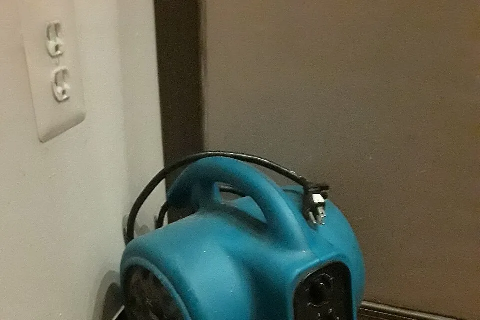 Representative portable drying equipment beside a wall